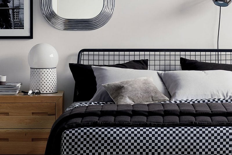 Metal bed frame from CB2 with black and white palette for the linens, best bed stores to buy a bed in Toronto 