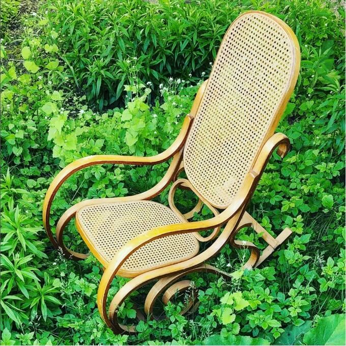 Mid-Century Modern wood rocking chair in grassy field